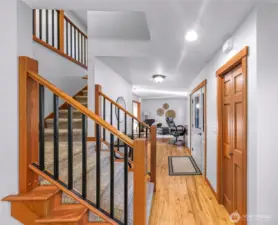 Interior stairway features warm wood detailing and solid craftsmanship. A functional connection between levels that adds architectural interest.