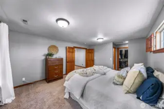 Upper-level bedroom offers comfortable proportions and natural light. Ideal for guests, family, or flexible use.