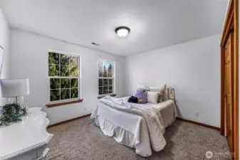 Additional bedroom with peaceful views and ample space. Neutral palette allows for versatile use.