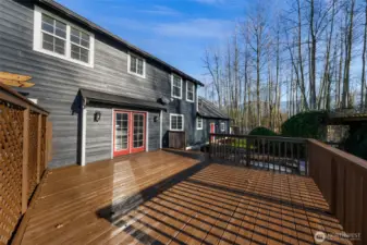 Expansive deck extends living outdoors, offering space for entertaining, relaxing, or enjoying the surrounding land. A natural extension of the home.