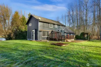 Open yard area showcases the usability of the land near the home. Flat, accessible space ideal for gardens, animals, or recreation.