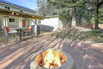 Enjoy the outdoor fire pit all year round, next to the covered patio with additional fireplac.