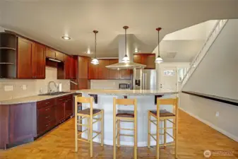 View from the dining room showing the kitchen and the front door entry.
