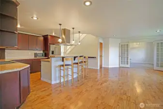 Enjoy the open living concept.  View from the dining room showing the kitchen, living room leading to the main level office/den.