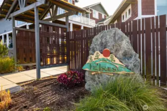 Community signage with an attractive entrance to access main level entry of home.