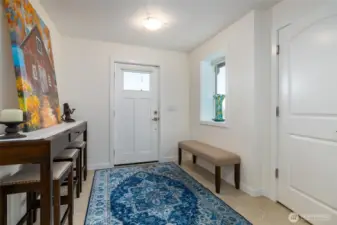 View from stairs of lower level entry, interior access to garage on right.