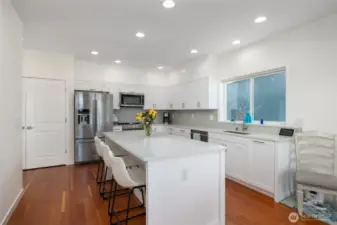 View of kitchen as you stand in the middle of the open concept floor plan on the main level.