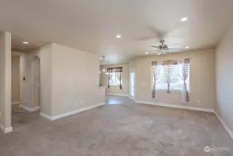 Walking into the open great room with ceiling fan