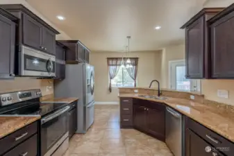 Gorgeous kitchen with granite countertops. All appliances are stainless steel and are included in the sale