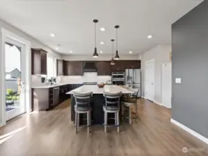 Boasting sleek sophistication, the chef's kitchen features exquisite slab quartz aounters, complemented perfectly by the convenience of a gas cook top and a designated wine bar, setting the stage for culinary excellence and entertaining alike.