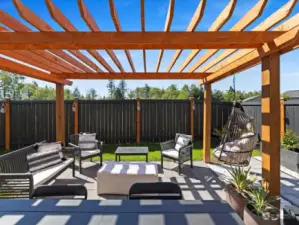 Step into your own private oasis in the backyard of this stunning home, where lush green grass, a newly built pergola, and charming garden spaces await, creating a tranquil retreat for outdoor living and entertaining.