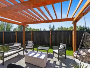 Adjacent to the pergola, a patio BBQ area awaits, complete with all the essentials for outdoor cooking and dining. Whether you're grilling up a feast for friends and family or enjoying a casual meal under the open sky, this versatile space is ready to accommodate all your culinary adventures.