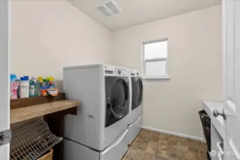 The laundry room is conveniently located on the upper level.