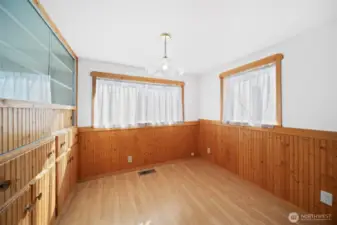 Dining room with adorable wainscotting and lots of storage.