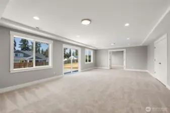 Sliding glass doors open on to the lower level patio, while french doors lead into an extra flex room.