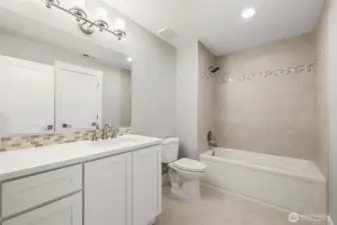 The fresh and bright lower level bath is conveniently assessible from both the secondary guest suite and the bonus/rec room.