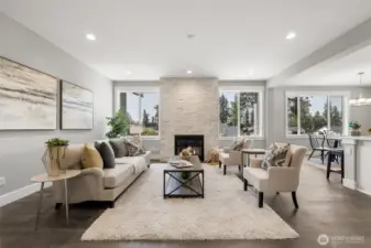 The inviting living room is luxurious yet comfortable.  The floor to ceiling stone fireplace is a stunning centerpiece to this beautiful space.