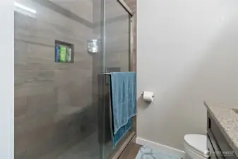 Walk in tiled shower.
