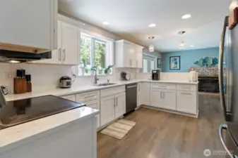 Bright kitchen with a pantry next to fridge.