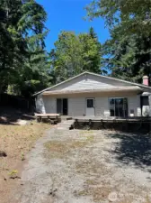 This is the "back yard" of 12318 4th Ave S. There is a concrete pad to park on.