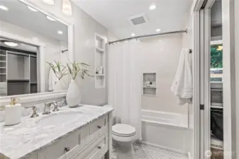 The primary ensuite bathroom features a modern designer vanity and bathtub perfect for relaxing after long days