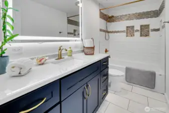 Lovely custom tile accents in main bath.