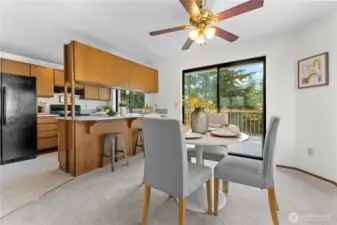 Kitchen dining combo, sliding door leads to deck.