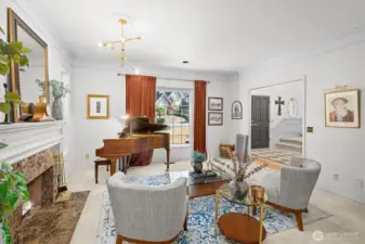 Formal living room with view into the grand foyer & Large Wood Burning Fire Place
