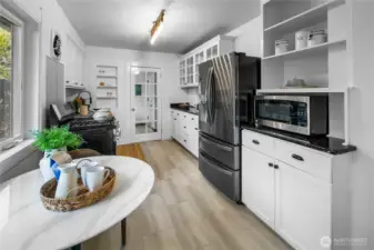 Kitchen has lots of storage and has also been recently updated with new luxury vinyl tile floors, new stove, lighting and newer refrigerator too. Through the door you'll find the mud room, washer/sryer, and back door leading to the yard, basement, garage and "Casita"