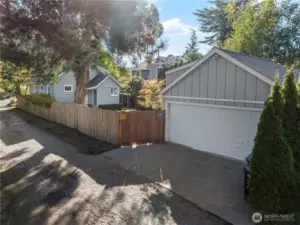 Exterior shot of the garage and a little bit of the house, as shown from the alley. Directly to the left of the shot are the playfields.