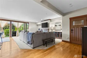 Front door entry with open floorplan to living room and kitchen