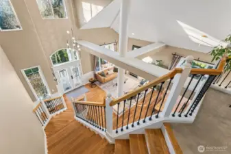 View looking from the top of the stairs down towards the entry and living/dining area.