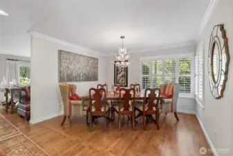 The formal dining room is a true centerpiece of the home—both elegant and inviting. Rich hardwood floors add warmth and character, while large windows bathe the space in natural light. With its generous proportions, the room easily accommodates gatherings of family and friends, making it ideal for both intimate dinners and grand celebrations. Thoughtful details and seamless flow to the kitchen and living areas create the perfect setting for entertaining in style.