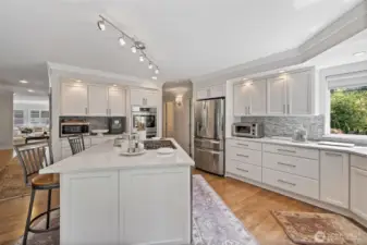 From another vantage point, the kitchen reveals its full sense of space and flow. Natural light streams through large windows.  Every detail has been thoughtfully designed to balance style, convenience, and comfort, making this kitchen a true centerpiece of the home.