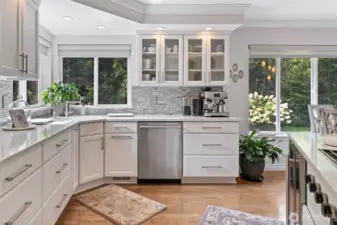 From this vantage point, the kitchen seamlessly connects to the outdoors, with large windows framing breathtaking views of the luxury acreage. Natural light floods this space.