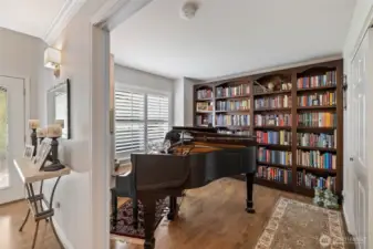 Large windows fill the den with natural light, highlighting the room’s inviting ambiance. Perfect for a home office, reading retreat, or cozy family gathering spot, this versatile space balances elegance and comfort, making it a cherished part of the home.