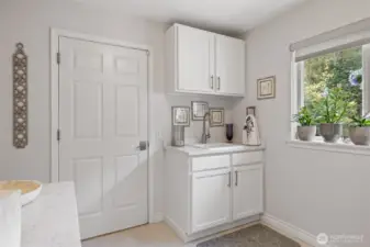 The spacious utility room combines modern convenience with thoughtful design. Outfitted with top-of-the-line appliances, it offers efficiency and style for everyday living. Ample counter space makes laundry and household tasks a breeze, while the room’s generous size provides plenty of flexibility for organization.