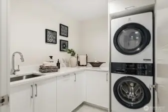 Well-appointed laundry with thoughtful storage.
