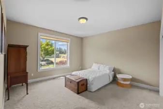 The main-level bedroom with an adjacent full bathroom creates a private and comfortable retreat ideal for guests or multigenerational living.