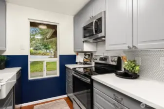 White quartz countertops create a seamless bright, clean kitchen space