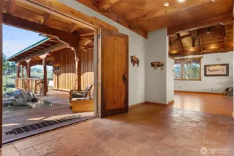 It can be difficult to decide, here, whether to go in or out because both are lovely and they compliment each other so well. The main entry hall is expansive and welcoming with practical stone floors and an immediate pull into the great room beyond.