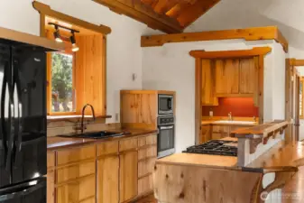 A custom island with propane range, copper countertop around the sink and a large buttler's pantry make this compact kitchen efficient, functional and a delight to be in!