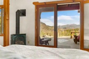 Wake up to this view! The primary suite includes a propane fireplace and french doors to a private porch steps away from the hot tub.