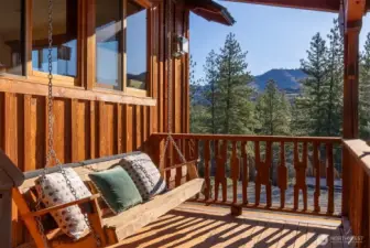 Pause awhile on this porch swing beside the private entrance to the studio apartment.