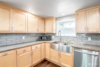 Newer maple cabinets & concrete countertops with farmhouse sink!