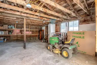 Inside the HUGE shop/garage! Riding lawn mower conveys with the home!