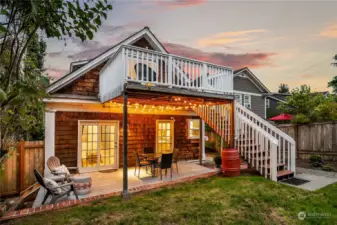 The back of the house has a covered patio and deck from the upper floor.