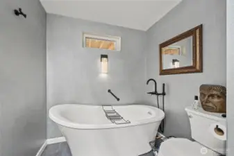 The freestanding soaking tub is an excellent place to relax and unwind after a long day.