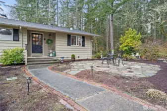 As you approach the front door, notice the stone patio to the right, where enjoying a morning cup of coffee can be a part of your routine on beautiful summer days.