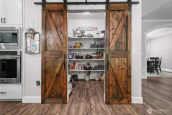Large pantry with custom barn door.